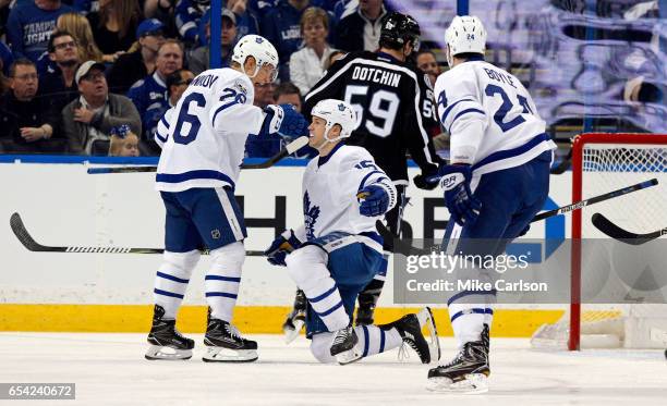 Matt Martin of the Toronto Maple Leafs is congratulated by Nikita Soshnikov after scoring against the Tampa Bay Lightning during the second period at...