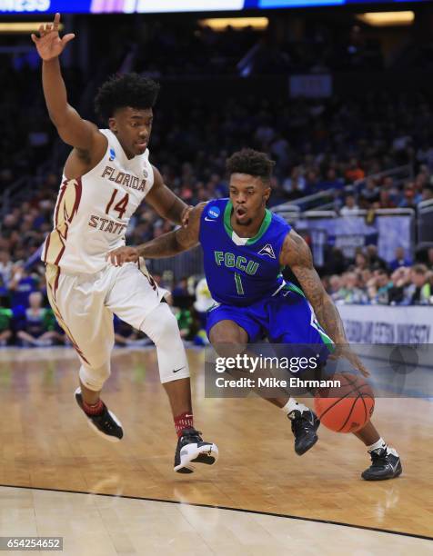 Reggie Reid of the Florida Gulf Coast Eagles drives against Terance Mann of the Florida State Seminoles in the first half during the first round of...