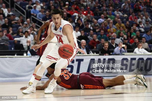Bronson Koenig of the Wisconsin Badgers drives against Zach LeDay of the Virginia Tech Hokies in the first half during the first round of the 2017...