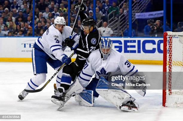 Brown of the Tampa Bay Lightning is sandwiched between Alexey Marchenko and Frederik Andersen of the Toronto Maple Leafs during the second period at...