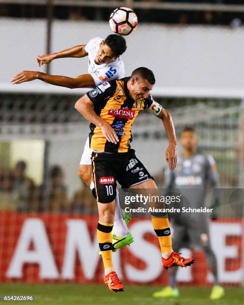 Lucas Verissimo of Santos and Pablo Escobar of The Stronguest in action during the match between Santos of Brazil and The Strongest of Bolivia for...