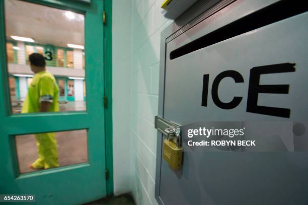 An immigration detainee stands near an US Immigration and Customs Enforcement grievance box in the high security unit at the Theo Lacy Facility, a...