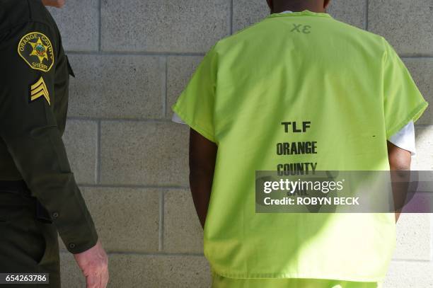 Sheriff's deputy speaks to an immigration detainee at the Theo Lacy Facility, a county jail which houses convicted criminals as well as immigration...