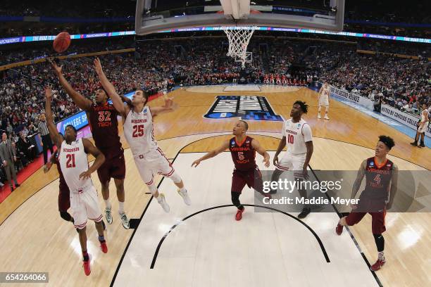 Zach LeDay of the Virginia Tech Hokies rebounds against Khalil Iverson and Alex Illikainen of the Wisconsin Badgers in the first half during the...