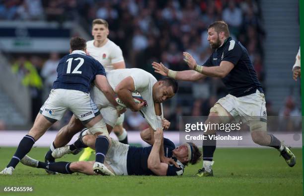 Billy Vunipola of England is tackled by Hamish Watson of Scotland during the RBS Six Nations match between England and Scotland at Twickenham Stadium...