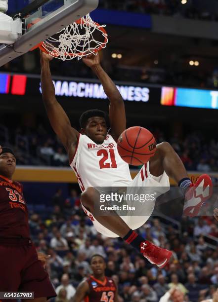 Khalil Iverson of the Wisconsin Badgers dunks against Zach LeDay of the Virginia Tech Hokies in the first half during the first round of the 2017...