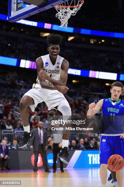 Jonathan Isaac of the Florida State Seminoles reacts after dunking the ball in the second half against the Florida Gulf Coast Eagles during the first...