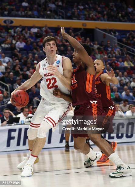 Ethan Happ of the Wisconsin Badgers drives against Zach LeDay of the Virginia Tech Hokies in the second half during the first round of the 2017 NCAA...