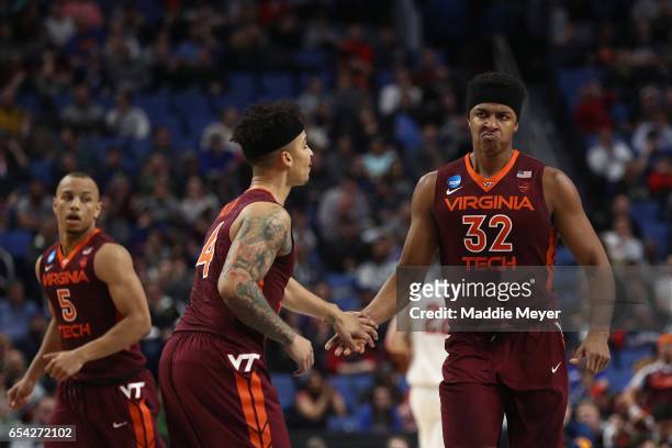 Zach LeDay and Seth Allen of the Virginia Tech Hokies show camaraderie against the Wisconsin Badgers in the second half during the first round of the...