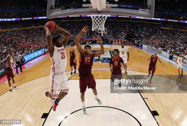 Khalil Iverson of the Wisconsin Badgers shoots against Zach LeDay of the Virginia Tech Hokies in the first half during the first round of the 2017...