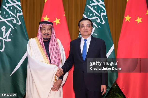 Chinese Premier Li Keqiang shakes hands with Saudi Arabia's King Salman bin Abdulaziz Al Saud at Great Hall of the People on March 17, 2017 in...