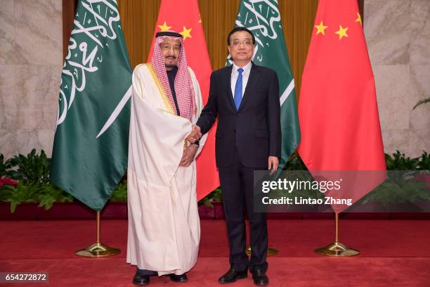 Chinese Premier Li Keqiang shakes hands with Saudi Arabia's King Salman bin Abdulaziz Al Saud at Great Hall of the People on March 17, 2017 in...