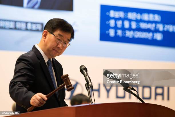 Lee Won-Hee, president of Hyundai Motor Co., hits a gavel during the annual shareholders meeting at the company's headquarters in Seoul, South Korea,...