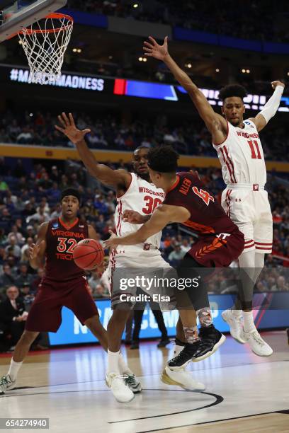 Seth Allen of the Virginia Tech Hokies passes to teammate Zach LeDay against Vitto Brown and Jordan Hill of the Wisconsin Badgers in the second half...