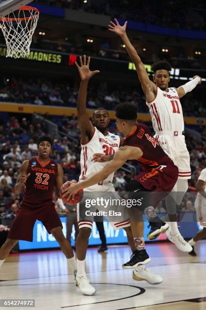 Seth Allen of the Virginia Tech Hokies looks to pass to teammate Zach LeDay against Vitto Brown and Jordan Hill of the Wisconsin Badgers in the...