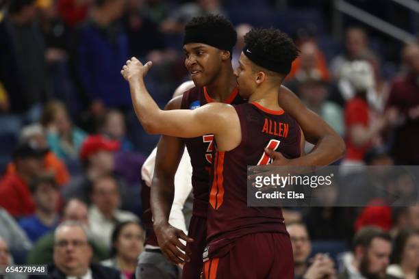 Zach LeDay of the Virginia Tech Hokies hugs Seth Allen after he fouls out of the game in the second half against the Wisconsin Badgers during the...
