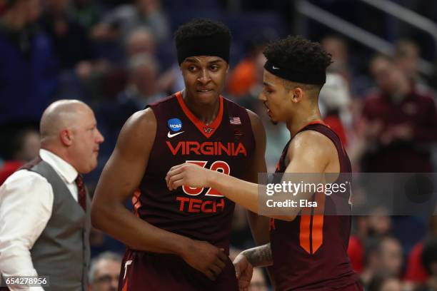 Zach LeDay of the Virginia Tech Hokies hugs Seth Allen after he fouls out of the game in the second half against the Wisconsin Badgers during the...