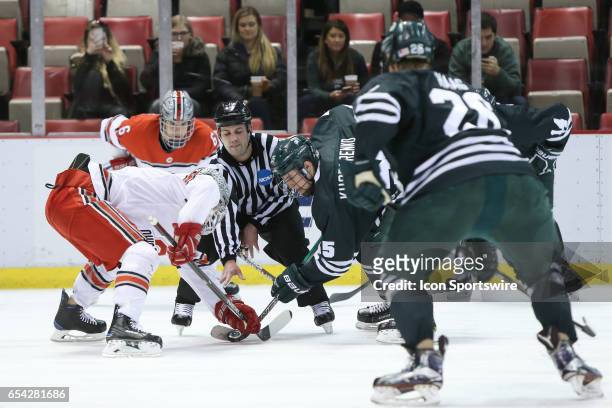 Michigan State Spartans forward Patrick Khodorenko battles for control of the puck against Ohio State Buckeyes forward John Wiitala during a face-off...