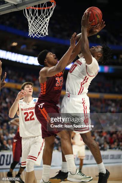 Virginia Tech Hokies forward Zach LeDay fouls Wisconsin Badgers forward Nigel Hayes during the NCAA Division 1 Men's Basketball Championship first...
