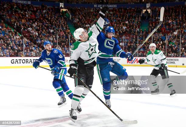 Jayson Megna of the Vancouver Canucks and Devin Shore of the Dallas Stars jump to reach a puck during their NHL game at Rogers Arena March 16, 2017...