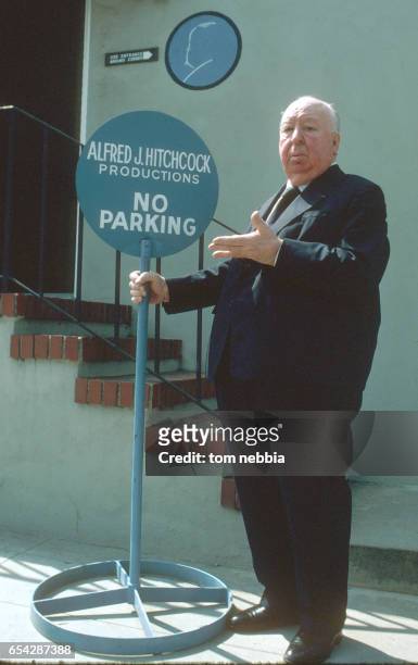 Portrait of British film director Alfred Hitchcock as he stands beside a 'No Parking' sign at Universal Studios, Universal City, California, 1978.