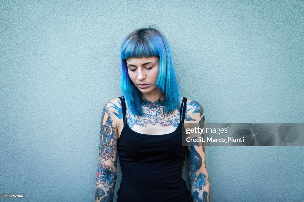 Young tattooed women with blue hair