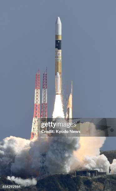 An H-2A rocket carrying a government intelligence-gathering satellite lifts off from the Tanegashima Space Center on Tanegashima Island, southwestern...