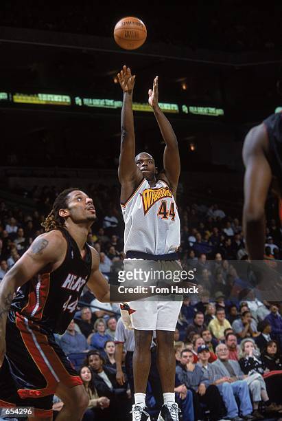 Marc Jackson of the Golden State Warriors takes a shot against Brain Grant of the Miami Heat during the game at The Arena of Oakland in California....