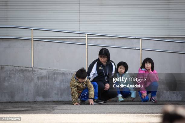 Students and their teacher are seen at the Hokuyou Elementary School during a missile evacuation drill on Friday, March 17 in Kitaura, Oga, Akita...