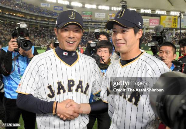 Manager Hiroki Kokubo and Designated hitter Tetsuto Yamada of Japan shake hands after the World Baseball Classic Pool E Game Four between Cuba and...