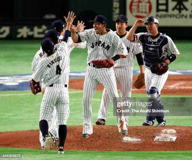 Infielder Sho Nakata and Japanese players celebrate after the World Baseball Classic Pool E Game Four between Cuba and Japan at the Tokyo Dome on...