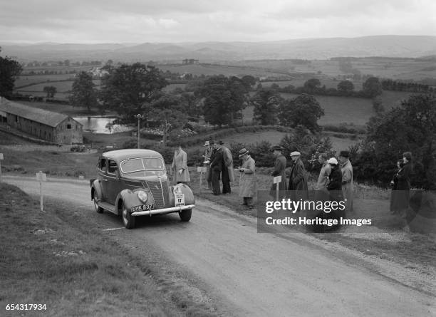 Ford V8 saloon of Viscountess Chetwynd competing in the South Wales Auto Club Welsh Rally, 1937 Artist: Bill Brunell. Ford V8 Saloon. 1936 Vehicle...