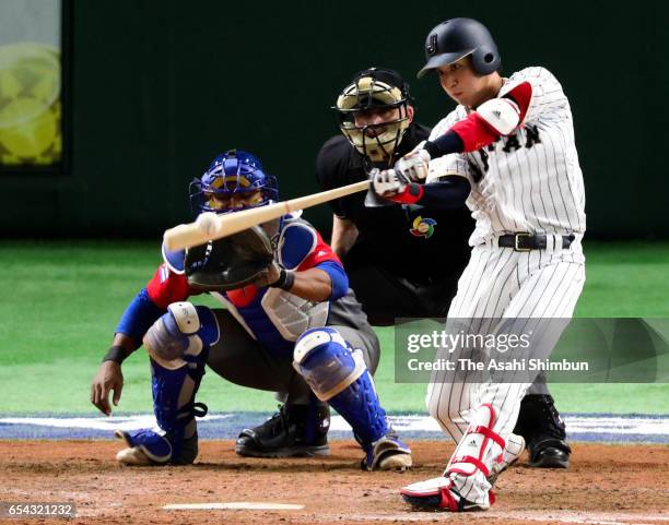 Designated hitter Tetsuto Yamada of Japan hits a two run homer in the bottom of the eighth inning during the World Baseball Classic Pool E Game Four...