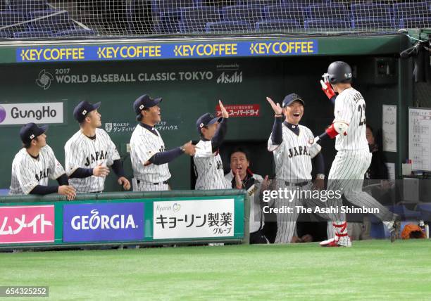 Designated hitter Tetsuto Yamada of Japan hits a solo homer in the bottom of the first inning during the World Baseball Classic Pool E Game Four...