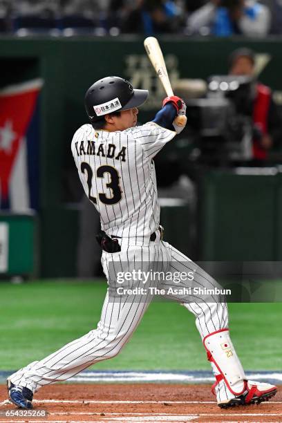 Designated hitter Tetsuto Yamada of Japan hits a solo homer in the bottom of the first inning during the World Baseball Classic Pool E Game Four...