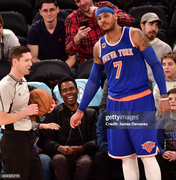 Carmelo Anthony greets Chris Rock during a timeout at Brooklyn Nets Vs. New York Knicks game at Madison Square Garden on March 16, 2017 in New York...