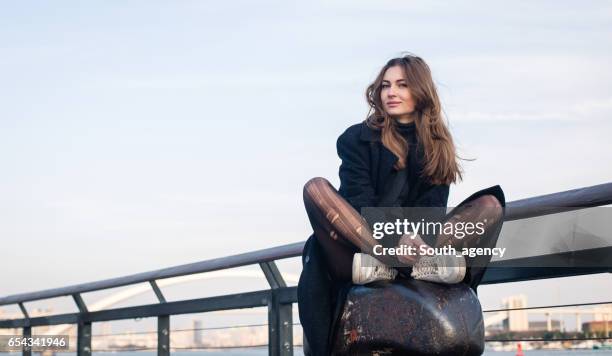 girl sitting on the dock - nylon stock pictures, royalty-free photos & images