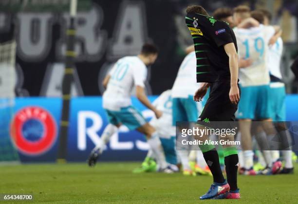 Andreas Christensen of Moenchengladbach reacts as players of Schalke celebrate after the UEFA Europa League Round of 16 second leg match between...