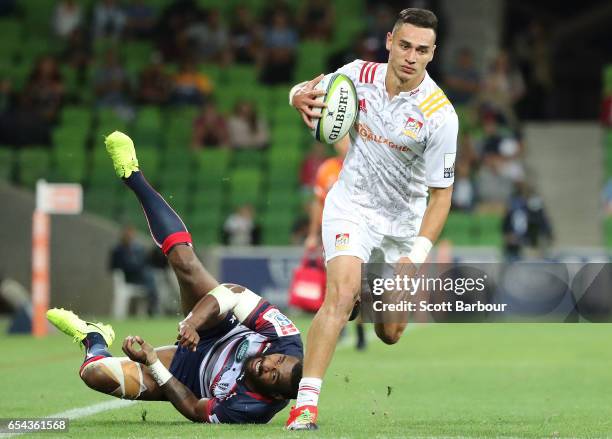 Shaun Stevenson of the Chiefs beats the tackle of Marika Koroibete of the Rebels and runs in to score the final try of the match during the round...