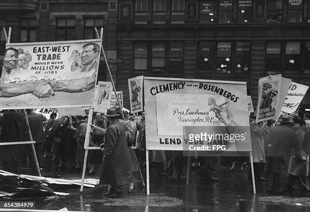 May Day demonstrators in Union Square, New York, with a poster calling on US President Dwight D. Eisenhower to show clemency to American couple...