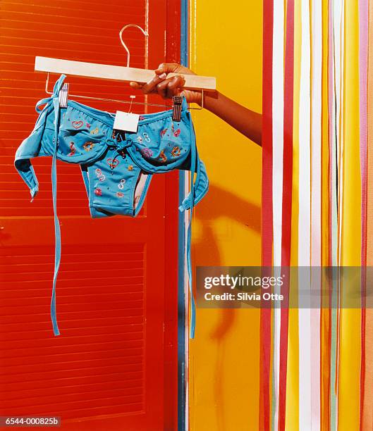 shopper's arm and fitting room - swimwear stock-fotos und bilder