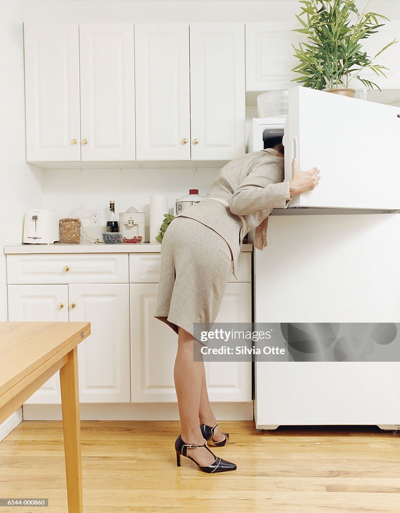 Woman with Head Inside Freezer