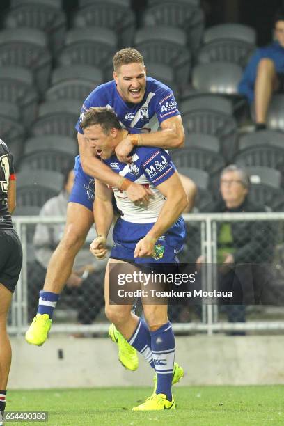 Bulldogs players celebrate after scoring a try during the round three NRL match between the Bulldogs and the Warriors at Forsyth Barr Stadium on...