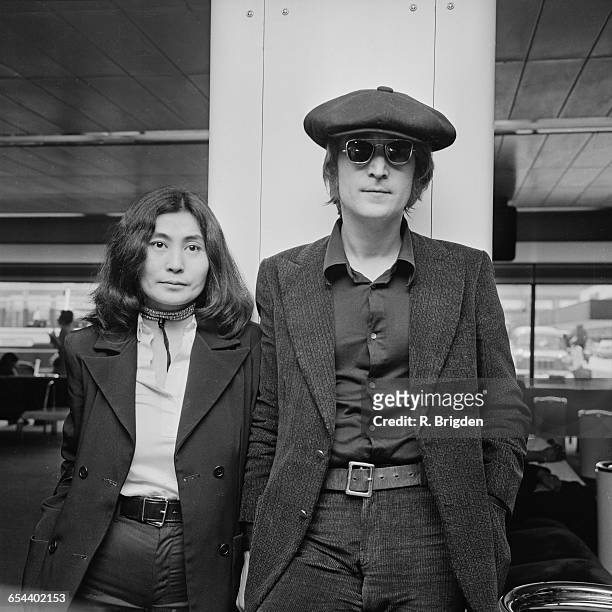 Singer and songwriter John Lennon and his wife Yoko Ono arrive at London Airport from New York, 14th July 1971.