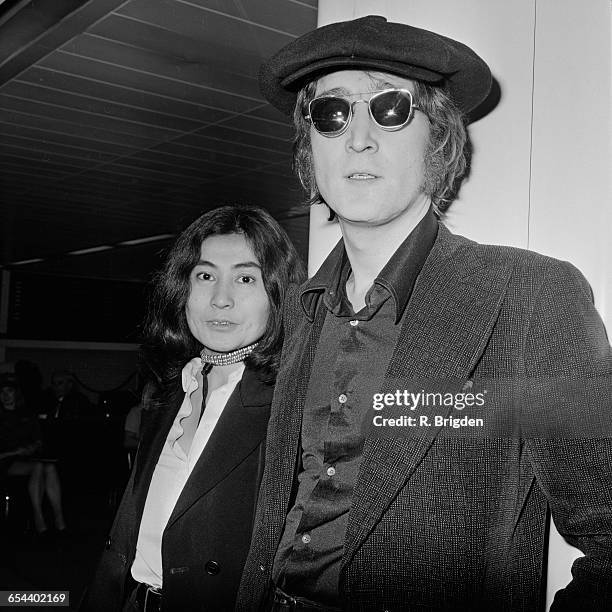 Singer and songwriter John Lennon and his wife Yoko Ono arrive at London Airport from New York, 14th July 1971.