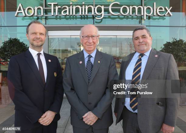 Executive Vice Chairman Ed Woodward and Sir Bobby Charlton of Manchester United pose with Lou McGrath OBE, Chief Executive of Find A Better Way, a...