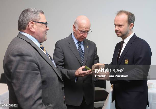 Executive Vice Chairman Ed Woodward and Sir Bobby Charlton of Manchester United talk with Lou McGrath OBE, Chief Executive of Find A Better Way, a...