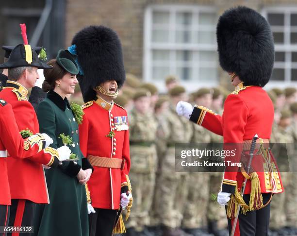 Catherine, Duchess of Cambridge presents the 1st Battalion Irish Guardsmen with shamrocks during the annual Irish Guards St Patrick's Day Parade at...