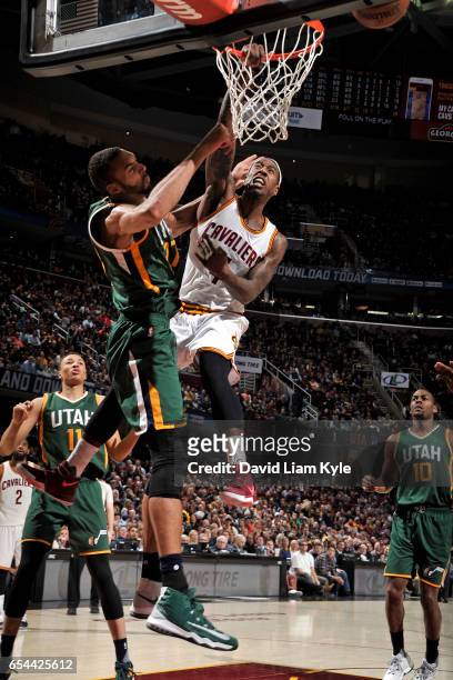 Iman Shumpert of the Cleveland Cavaliers dunks the ball over Rudy Gobert of the Utah Jazz during the game on March 16, 2017 at Quicken Loans Arena in...