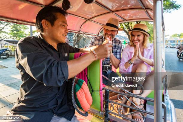 äldre par på semester respektfullt betala tuktuk transport driver i thailand - motorriksha bildbanksfoton och bilder